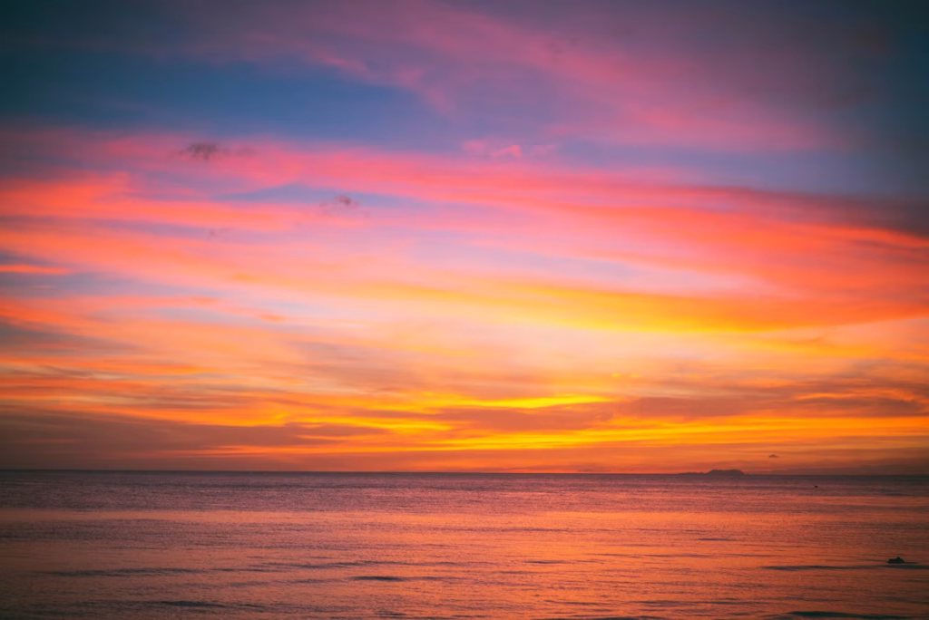 Colorful tropical sunset over calm ocean