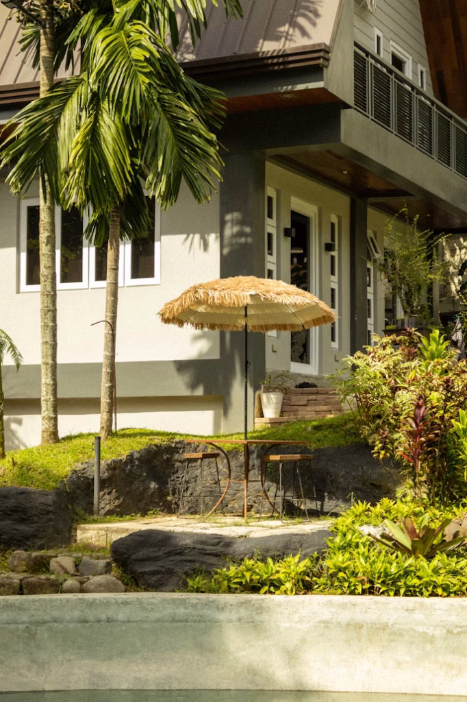 Small tropical hotel with palm tree garden
